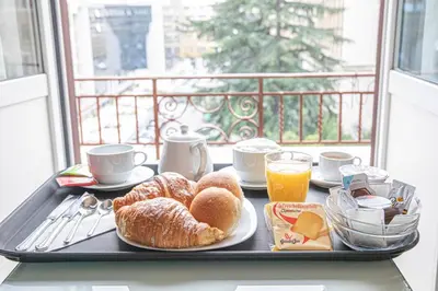 a tray with breakfast food on a table with a window at Residenza Castrense in Rome