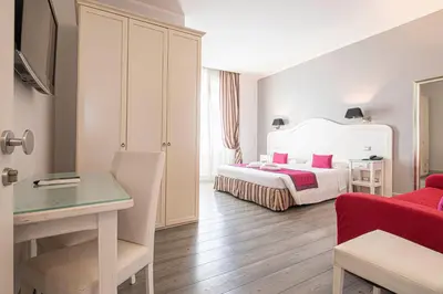 a bedroom with a bed and a desk in a room at Suite Castrense in Rome