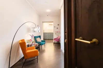 a hallway with chairs and a table in a room at Cloud 9 Hotel in Rome