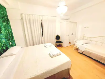 a white bedroom with two beds and a window at Vanity Apartment - 4 bedrooms with 4 bathrooms - AC & WIFI in Rome
