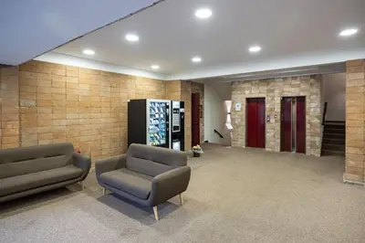 a lobby with two chairs and two red doors at Plaza Cheery Suite in Rome