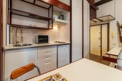 a small kitchen with a sink and a microwave at GuestHost - Piazza Navona Petite House in Rome