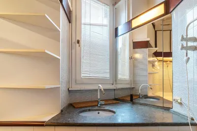a bathroom with a sink and a window at GuestHost - Piazza Navona Petite House in Rome