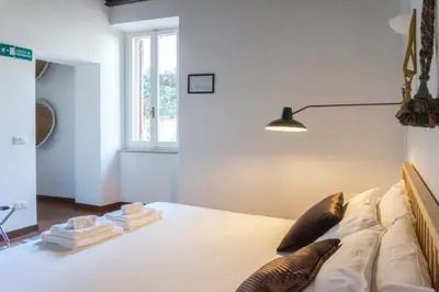 a bedroom with a bed with pillows on it at EasyTopStay - Cosy Flat near Castel S Angelo in Rome