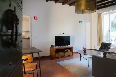 a living room with a television and a table at EasyTopStay - Cosy Flat near Castel S Angelo in Rome