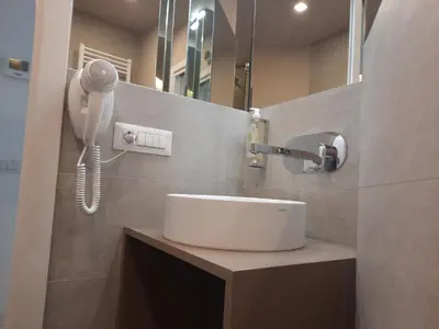 a bathroom with a sink and a hair dryer at La casa di Livia in Rome