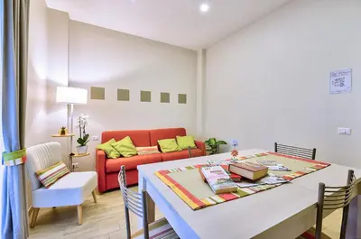 a living room with a table and a couch at Marigiò Vatican Apartment in Rome