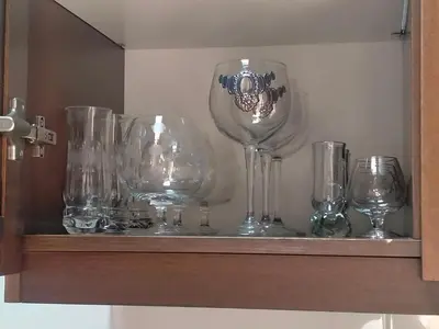 a shelf with several empty wine glasses on it at Attico con terrazza Santa Cecilia in Rome
