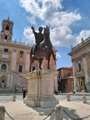 a statue of a man on a horse in front of a building at Attico con terrazza Santa Cecilia in Rome
