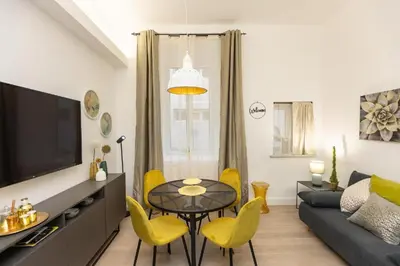a living room with a table and yellow chairs at SolferinoNove in Rome
