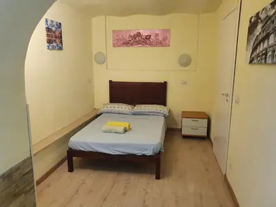 a bedroom with a bed with a yellow pillow on it at Holiday City Centre in Rome