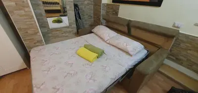 a bed with two pillows on top of it at Holiday City Centre in Rome
