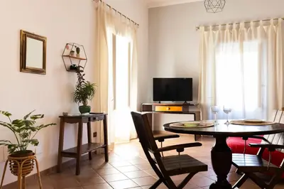 a living room with a table and chairs and a television at Obiettivo Roma in Rome