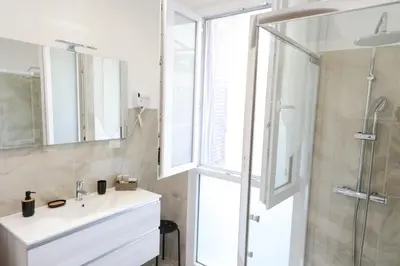 a bathroom with a white sink and a shower at Trastevere Magic House Luxury Suite in Rome