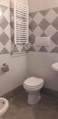 a bathroom with a toilet and a sink at Gioia Guest House in Rome