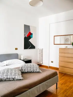 a bedroom with a bed and a painting on the wall at Modern 1 Bedroom near metro in Rome
