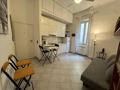 a kitchen and living room with a table and chairs at Cozy apartment in Rome Trastevere in Rome