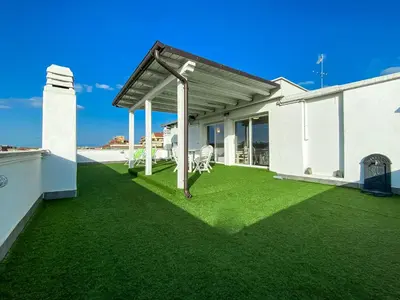 a patio with green grass on a white house at Al 13 - La Terrazza in Rome