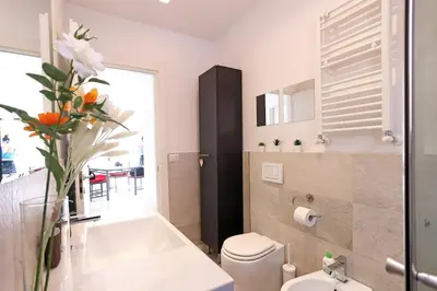 a bathroom with a white sink and a toilet at Casa Mapi in Rome