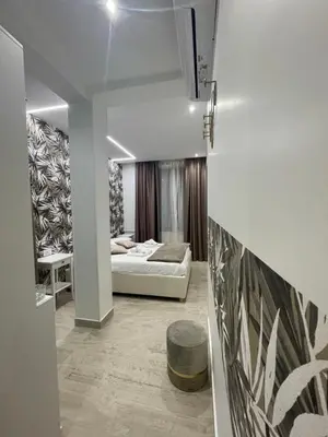 a living room with a white couch and a bed at Bobbio Holiday Rome in Rome