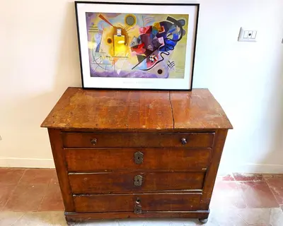 a picture on top of a wooden dresser with a painting on it at Terraces under the Moon in Rome