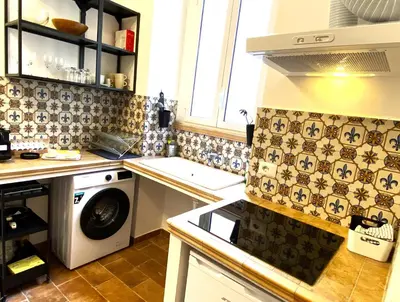 a kitchen with a washing machine and a washer at Terraces under the Moon in Rome