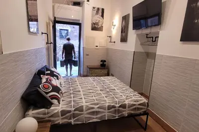 a bed in a room with a person walking through a doorway at Trastevere Home Gallery in Rome