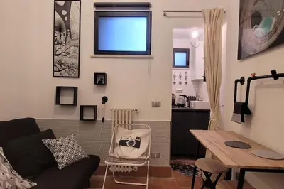 a living room with a couch and a table at Trastevere Home Gallery in Rome