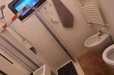 a bathroom with a toilet and a sink at Trastevere Home Gallery in Rome
