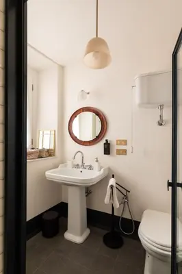 a bathroom with a sink and a toilet and a mirror at Charming Design Apartment in Monti in Rome