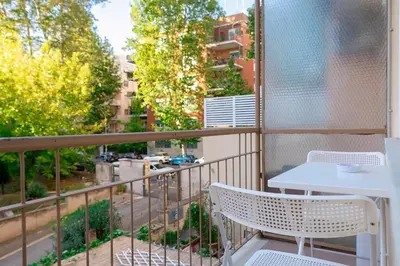 a balcony with a table and chairs and a view of a city at Roma SanPaolo Apartment in Rome