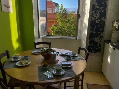 a wooden table with a bowl of fruit on it at Quiet in Biancamano - Metro A - San Giovanni - Centro Storico in Rome