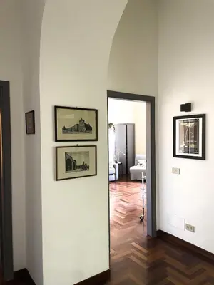 a room with two pictures on the wall and a hallway at Quiet in Biancamano - Metro A - San Giovanni - Centro Storico in Rome