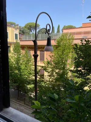 a street light in front of some trees at Quiet in Biancamano - Metro A - San Giovanni - Centro Storico in Rome