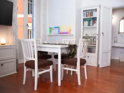 a dining room with a white table and chairs at Apartment Testaccio Piramide by Interhome in Rome