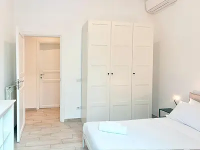 a white bedroom with a bed and a closet at DaliTourism - Vatican Apartment 193 in Rome
