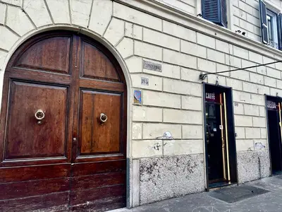 a large wooden door on the side of a building at DaliTourism - Vatican Apartment 193 in Rome