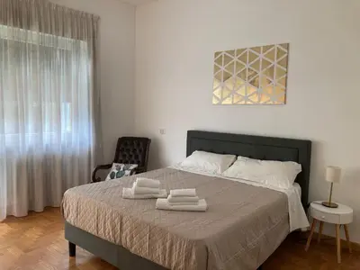 a bedroom with a bed with two towels on it at FAIROME Apartment 2 Pini in Rome