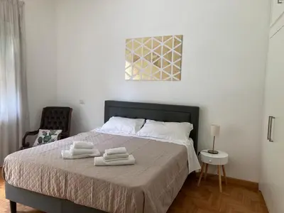 a bedroom with a bed with two towels on it at FAIROME Apartment 2 Pini in Rome