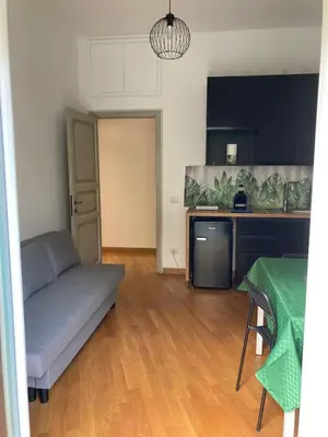 a living room with a couch and a kitchen at FAIROME Apartment 2 Pini in Rome