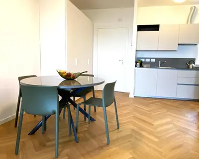 a kitchen and dining room with a table and chairs at Olmocolmo Trastevere in Rome