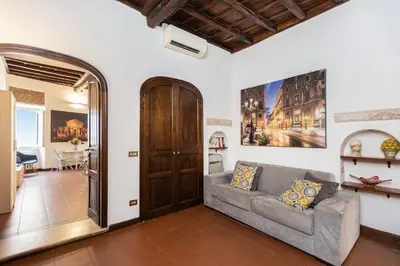 a living room with a couch and a table at Amazing Via del Babuino - Piazza del Popolo in Rome