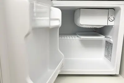an empty refrigerator with its door open with its door open at SorinaHome Vatican Studio in Rome