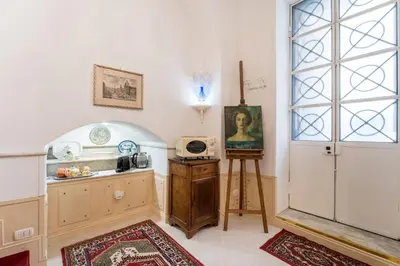 a kitchen with a window and a counter with a microwave at Studio d'Artista, Elegante Loft nel Cuore di Roma in Rome