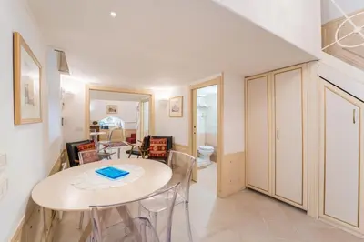 a kitchen and dining room with a table and chairs at Studio d'Artista, Elegante Loft nel Cuore di Roma in Rome