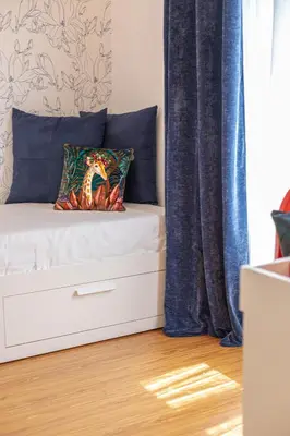a bedroom with a bed and a window with blue curtains at Minerva - Elegant New Classic close to Vatican in Rome