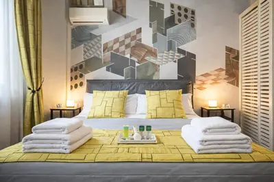 a bedroom with a bed and a couch at Vittoria House in Rome