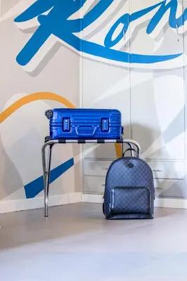 a blue suitcase sitting on a table next to a wall at MHouse Roma in Rome