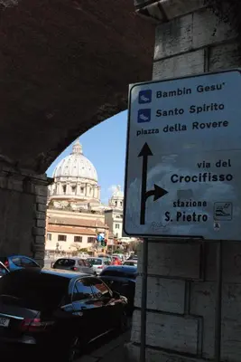 a street sign with a building in the background at Di Fronte alla Cupola in Rome