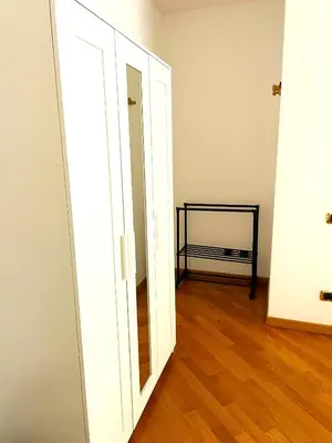 a white closet with a mirror and a wooden floor at Ammiragli Vatican Experience in Rome